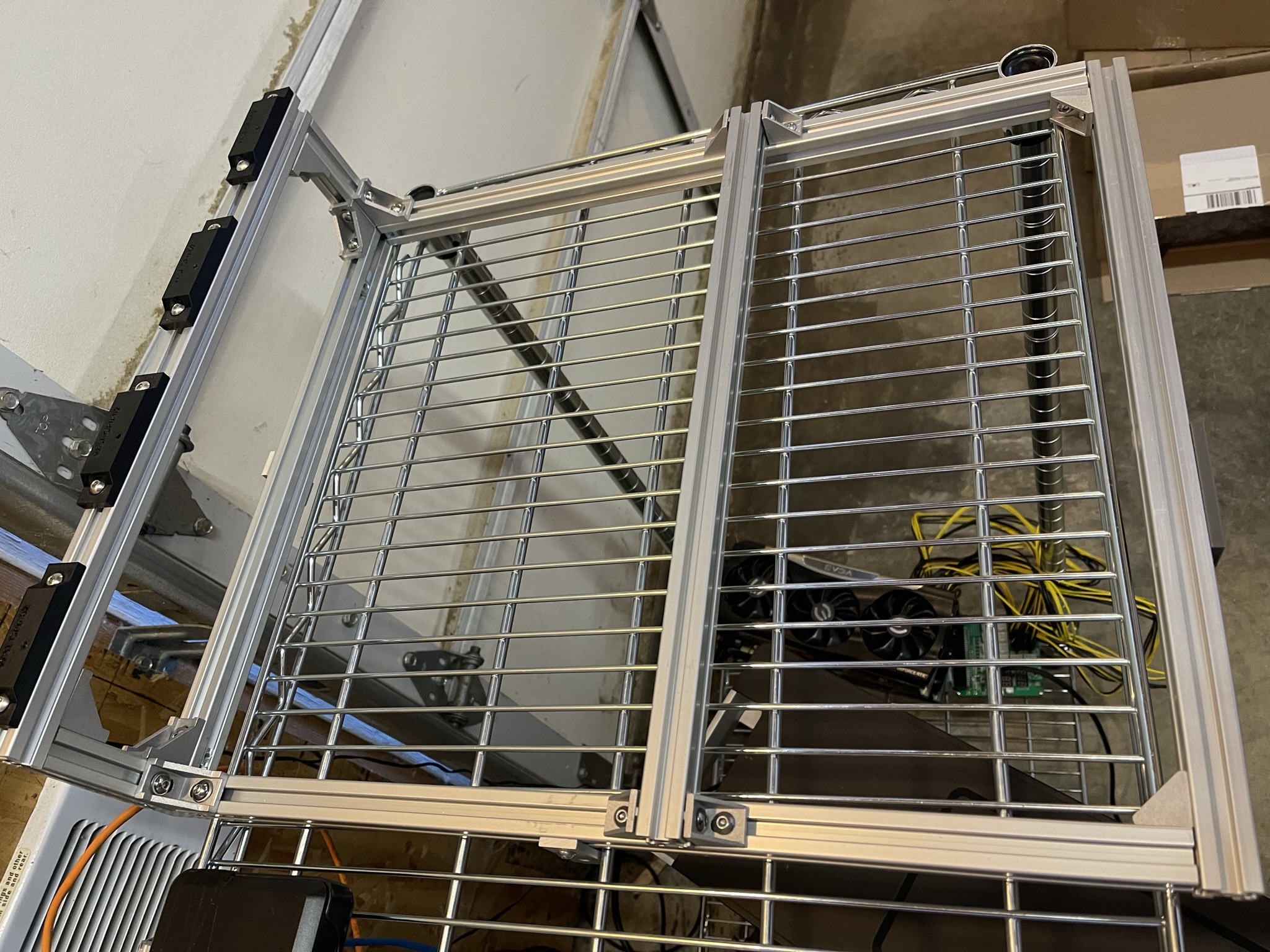 To support the heavy GPUs I've built from T-slot profiles a frame that rests on the computer case. I've also designed and 3D-printed the GPU mounts.